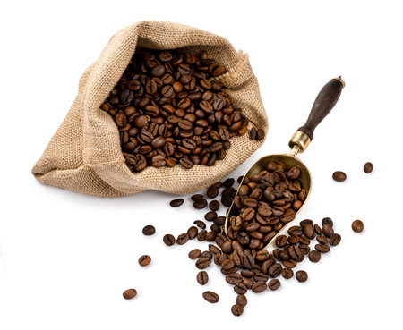 Scoop of coffee beans and a bag with coffee beans isolated. Coffee in scoop on white background. Top view of coffee.の写真素材