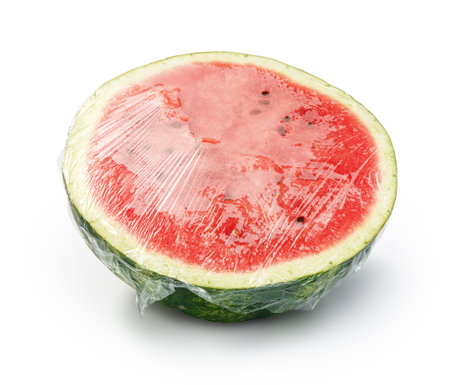 Watermelon with plastic food wrap. Watermelon with PVC Cling Film isolated on white.の写真素材