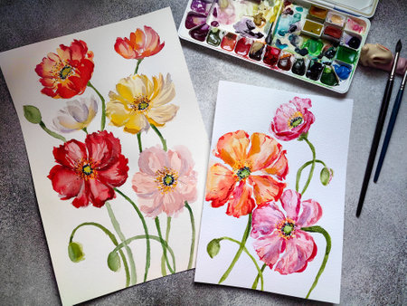 Watercolor drawing. Loose flowers and artistic equipment on desk. Top view. Watercolor poppies. Painter drawing at working place.の写真素材