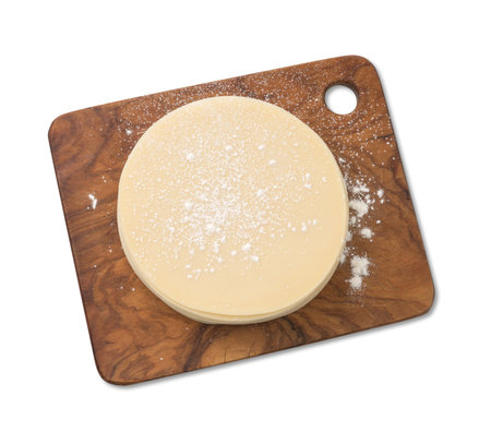 Stack of slices of dough on wooden board. Top view of dough.の写真素材