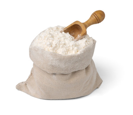 Bag with flour and wooden scoop isolated.の写真素材