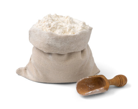 Bag with flour and wooden scoop isolated.の写真素材