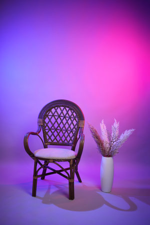A beautiful photo zone in a photo studio for photo shoots. Neon photo zone for portrait with country chair and table.の写真素材