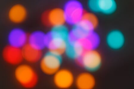 Blurred lights background. Glittering christmas effect. Abstract colorful pattern. Shimmering blur spots. Festive design.の写真素材