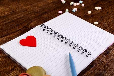 Woman diary with heart and Macaroons with marshmallows. Opened blank notebook. Valentines day concept with empty notepad.の写真素材