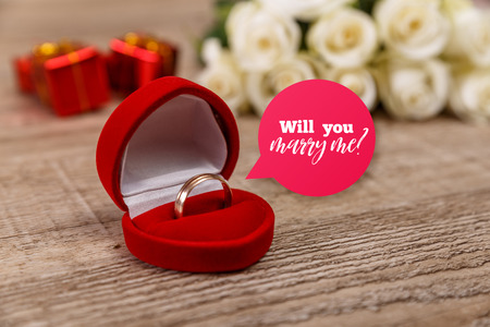White roses with engagement ring. Will you marry me design. Valentines day concept. Fresh natural flowers with gift boxes. Wooden rustic board.の写真素材