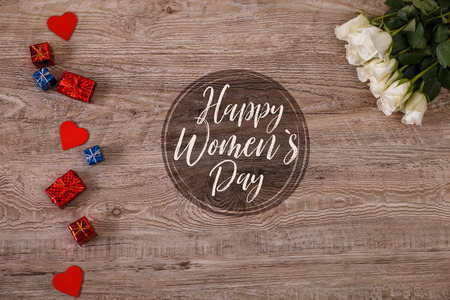 White roses with hearts on wood background. Love design. Happy Womens day, 8 march concept. Fresh natural flowers with gift boxes. Wooden rustic board.の写真素材