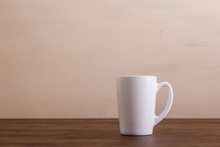 Mock-up mug. Mockup coffee or tea cup. Design concept for branding. Front view. Wooden rustic board.の写真素材