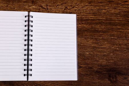 Notepad on the wooden rustic desk. Mockup design concept with empty notebook page. Mock-up of blank diary. Wooden rustic desk.の写真素材