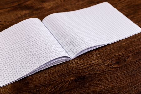 Notepad on the wooden rustic desk. Mockup design concept with empty notebook page. Mock-up of blank diary. Wooden rustic desk.の写真素材