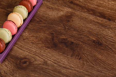 Macaroon cakes. Different types of macaron. Colorful almond cookies. French sweet dessert. Wooden rustic board.の写真素材