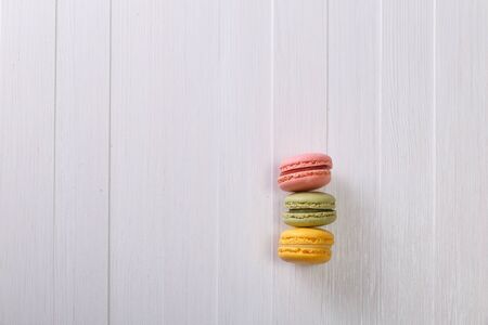Macaroon cakes. Different types of macaron. Colorful almond cookies. On white wooden rustic background.の写真素材