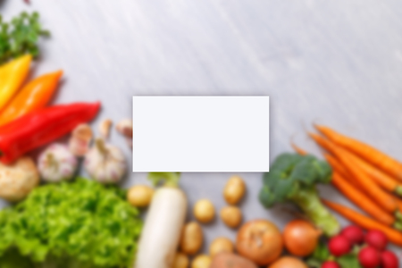 Business card mockup. Vegetables. Potatoes, onion and garlic. Pepper, brocoli and green salad. Celery, carrot and radish. Organic vegetables.の写真素材