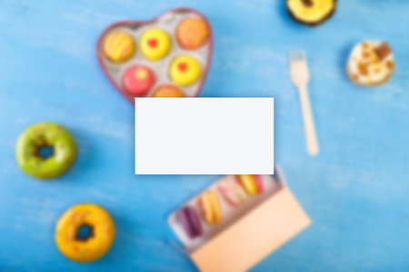 Business card mockup. Cupcakes, Macaroons and glazed donuts. Sweet dessert. Cakes with nuts cream....