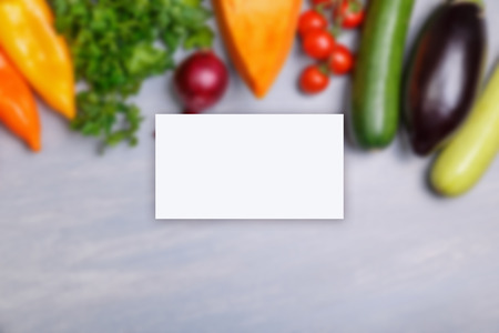 Business card mockup. Vegetables. Tomato, pepper and pumpkin. Squash, zucchini and eggplant. Onion with parsley. Organic food.の写真素材
