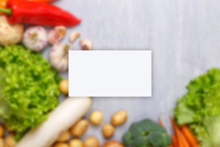 Business card mockup. Vegetables. Garlic, lettuce salad and pepper. Brocoli, celery and carrot. Organic food.の写真素材