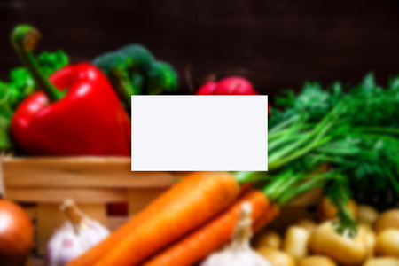 Business card mockup. Vegetables. Potatoes, carrot and red pepper. Lettuce salad, garlic and brocoli. Onion and radish.の写真素材