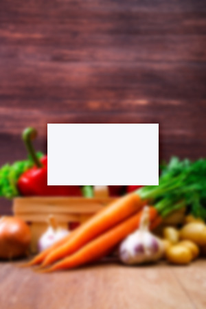 Business card mockup. Vegetables. Potatoes, carrot and red pepper. Lettuce salad, garlic and brocoli. Onion and radish.の写真素材