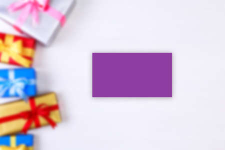 Business card mockup. Gift boxes with bow. Presents wrapped with paper and ribbons. Christmas or birthday packages. Celebration design.の写真素材