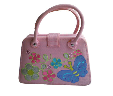 The handbag for the girl is pink colour with pastes and bright application.The handbag is isolated on a white background.の写真素材