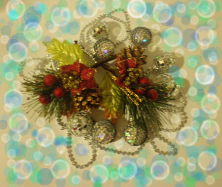 On a beige background with multi-coloured dim circles there is a Christmas composition.In the centre there is a green branch of a pine with red berries, brown cones, red bows, yellow leaves and silvery fur-tree spheres.の写真素材