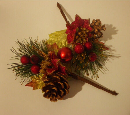 Beautiful decorative Christmas pine branches with berries and cones are on a beige background.の写真素材
