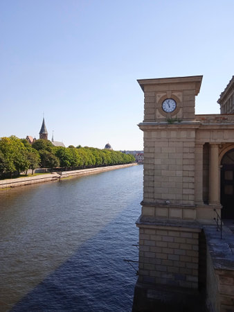 The clock tower on the bank of the river in the old townの写真素材
