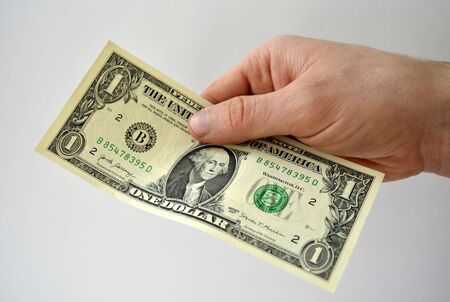 Hand holding money usa dollar isolated on white backgroundの写真素材