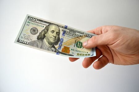 American dollars in hand isolated on white backgroundの写真素材