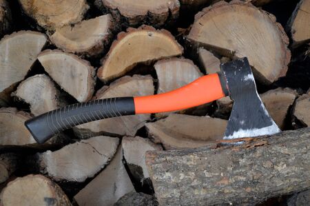 Ax stuck in a log against the background of lumberの写真素材