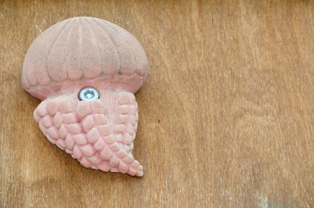 Pink jellyfish toy on wooden background with copy space