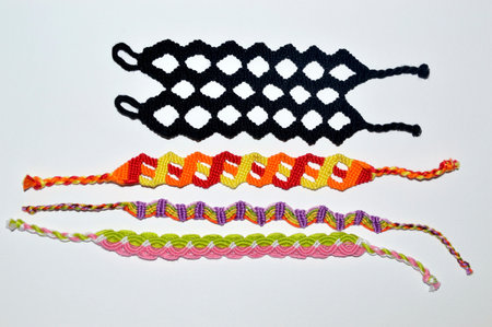 Multi-colored woven friendship bracelets with unusual braiding handmade of embroidery bright thread...