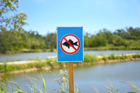 Prohibitory sign fishing is prohibited against lakes and forest in the park.