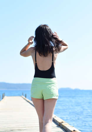 45 years old Russian woman standing on pier against Japanese seaの写真素材