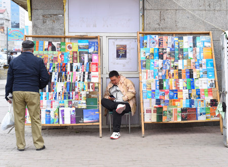 Ulaan Baatar, Mongolia - 05.13.2022: mongolian man sells many books in different languages  on the streetのeditorial素材