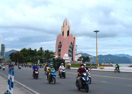 Nha Trang, Vietnam - 18 May 2022: famous tower Lotus and vietnamese driving bikesのeditorial素材