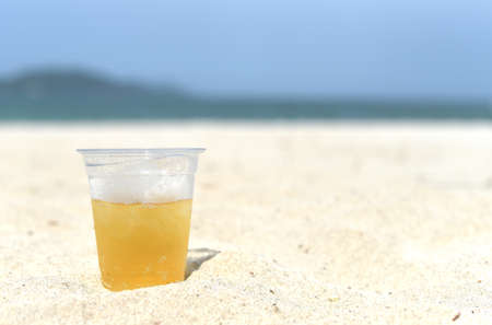 Cold vietnamese beer in cup with ice on white sand beach of Nha Trang Vietnamの写真素材