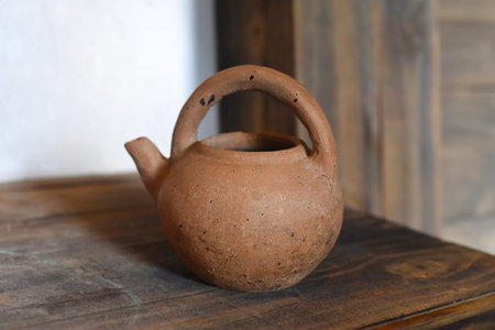 Clay teapot on a wooden table