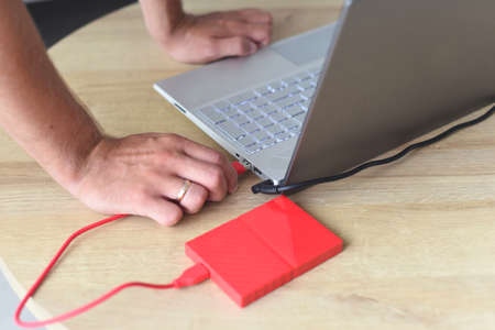 A hand plug a hard drive in computerの写真素材