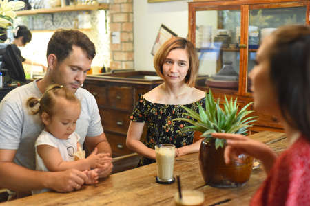 Young people communicate with each other in cafeの写真素材