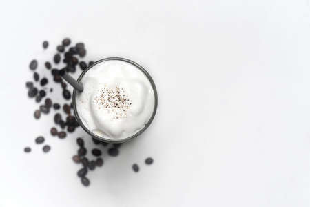 Ice latte with coffee beans isolated on white background top view closeupの写真素材
