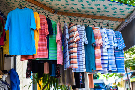 Many colorful t-shirts hanging in the vietnamese market in Nha Trangの写真素材