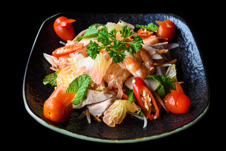 Thai salad made of shrimps and squid and onions isolated on black background side viewの写真素材