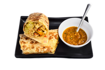 Vegetarian Mexican burrito with potato, tofu,rice served with sauce borrachaの写真素材