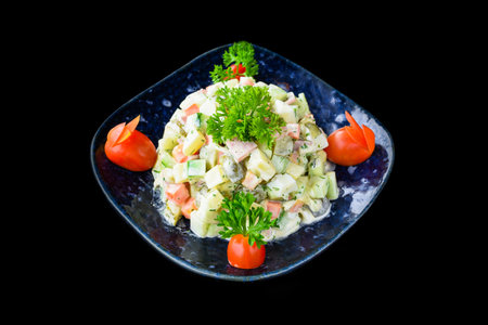Russian salad olivie on black background side viewの写真素材