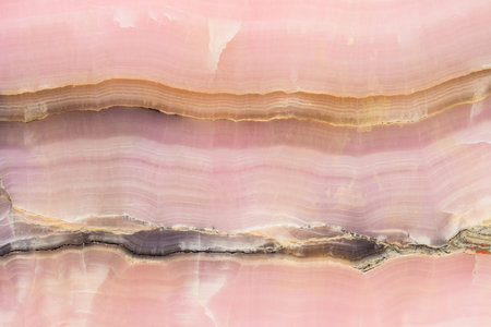 Light pink blurred background made of pink jade or Nephrite