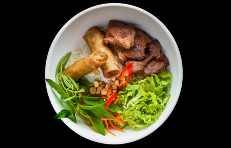 Traditional fried vietnamese spring rolls with pork served with rice noodles, fried pork and peanutsの写真素材