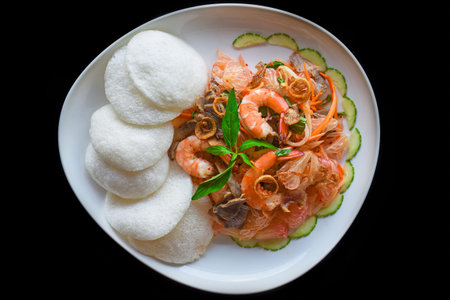 Salad made of shrimps and grapefruit isolated on black background top viewの写真素材