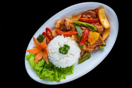 Stewed pork with vegetables and rice isolated on black background top viewの写真素材