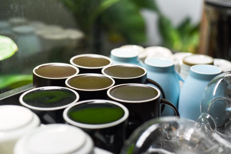 Many clean and washed mugs and cups in a row in kitchen with copy space